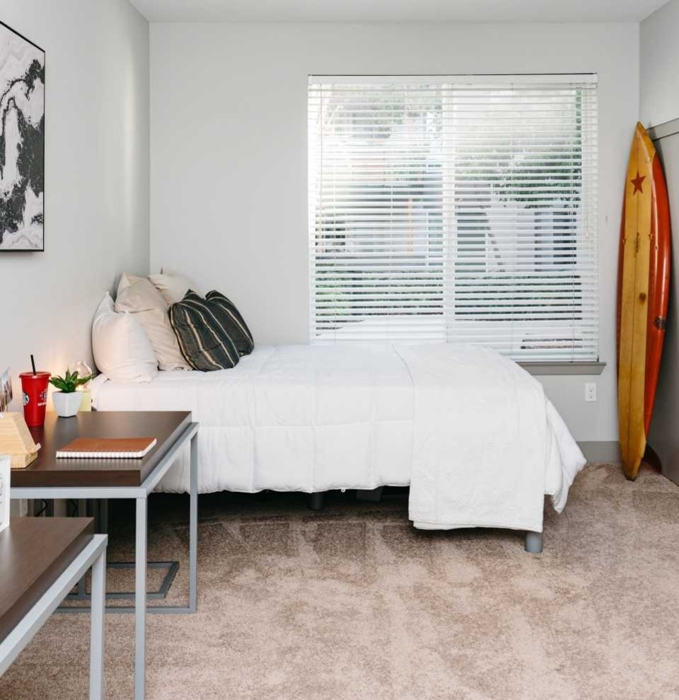 A bedroom with a study desk