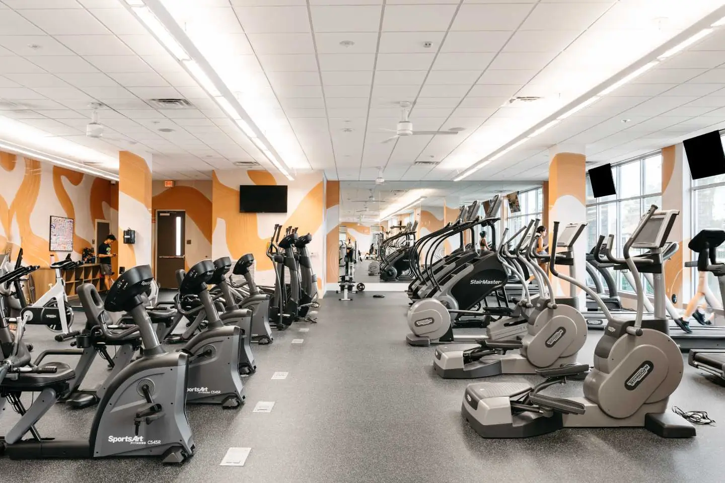 fitness room with various cardio equipment.