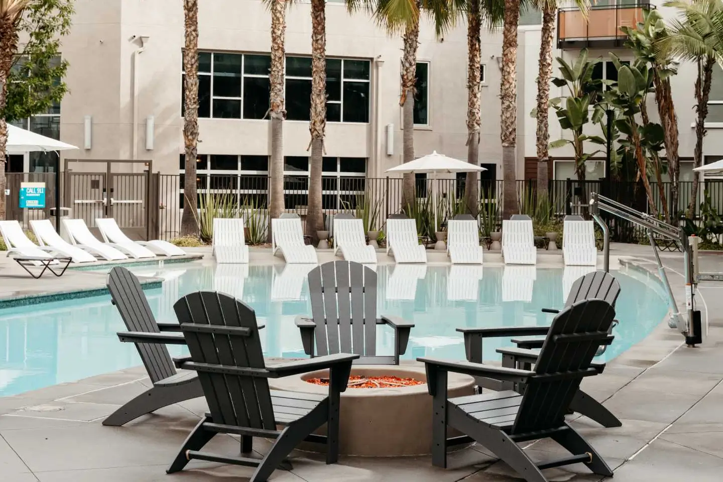 Pool with various seating options and a fire pit.